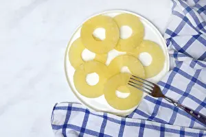 Exotic Food Still Life Drucke: Pineapple rings on plate with fork
