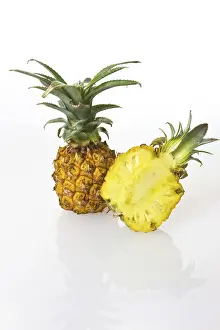 Fruit Still Life Photos Drucke: Two Pineapples (Ananas comosus), one cut in half