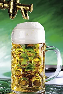Alcoholic Beverage Drucke: A pint of beer under the tap