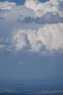 Dramatic Clouds Europe Drucke: Plane in front of dramatic clouds, Switzerland