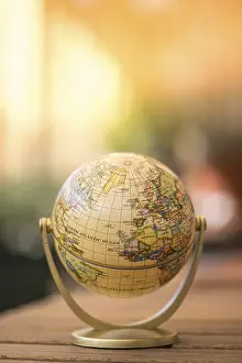 Rustic Table Setting Drucke: Planning the next journey: miniature globe on a rustic table