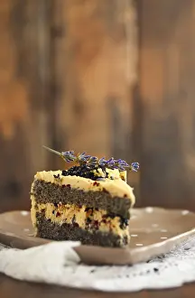 Baked Goods Assortment Drucke: Plate with one piece of lavender cake on the rustic background