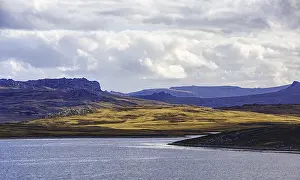 Cloudy Mountain Scenery Drucke: Playing light over mountains and water with dramatic clouds in the background