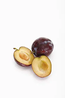 Vitamin Rich Plums Drucke: Two plums, one of them halved
