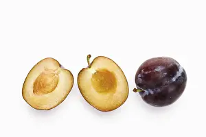 Vitamin Rich Fruit Photography Drucke: Plums, one of them halved with stone