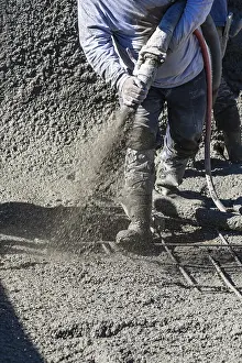 Real Estate Construction Industry Drucke: Pool construction worker shooting concrete