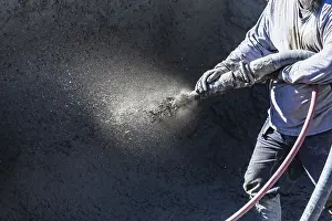 Swimming Pool Installation Drucke: Pool construction worker shooting concrete