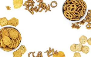 Light Colored Background Drucke: Portion of mixed Snacks isolated on white background (close up shot)