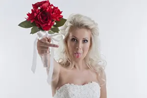 Studio Shot Of Bride Drucke: Portrait of funny young bride posing in studio