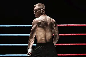 Mixed Martial Arts Athlete Drucke: Portrait of a kickboxer on the background of the ring