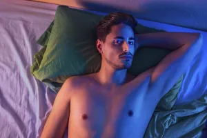 Young Man Portrait Drucke: Portrait of a young man on a bed from above