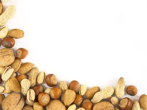 Studio Shot Of Hazelnuts Drucke: Background of mixed nuts in shell - hazelnuts