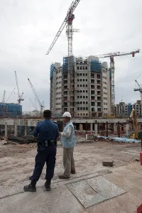 Crane On Construction Site Drucke: Construction worker on a construction site