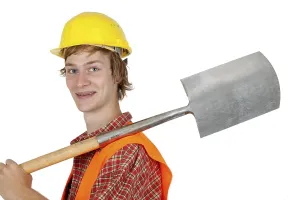 Hard Hat Protection Drucke: Young construction worker with digging tools on a white background
