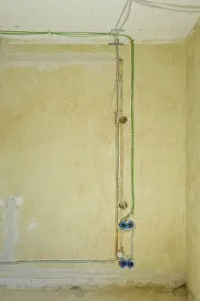 Construction Site Germany Drucke: Power and network cables on a wall