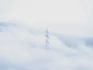 European Power Industry Scene Drucke: A power pole rises in a soft mist