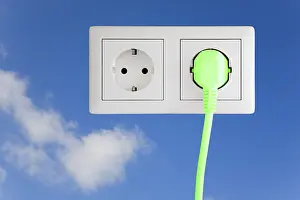 Alternative Energy Source Image Drucke: Power socket with a green plug against blue sky