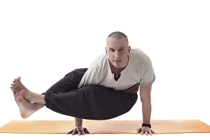 Meditation Pose Drucke: Practicing yoga trainer posing looking at camera
