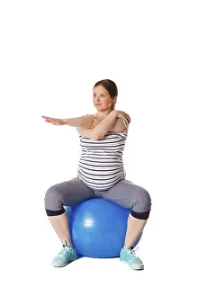 Pregnancy Exercise Drucke: Pregnancy exercise concept, pregnant woman doing stretching exercises with exercise ball isolated on white background