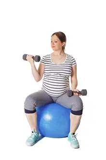 Pregnancy Exercise Drucke: Pregnancy exercise concept, pregnant woman doing exercises with exercise ball and barbells isolated on white background