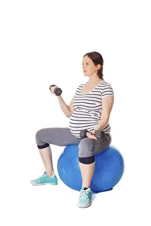 White Background Workout Drucke: Pregnancy exercise concept, pregnant woman doing exercises with exercise ball and barbells isolated on white background