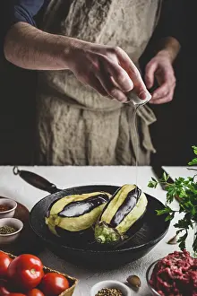 Eggplant Recipe Drucke: Preparing eggplants for baking and stuffing with ground beef and tomatoes