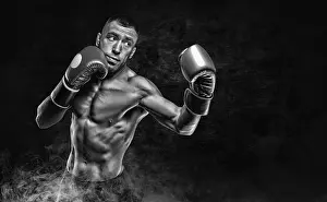 Fitness Training Studio Drucke: Professional boxer practicing blows in the smoke
