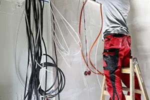 Power Distribution Box Installation Drucke: Professional electrical installation on a building shell