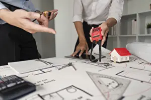 Building Inspection Drucke: Two professionals examine construction plans