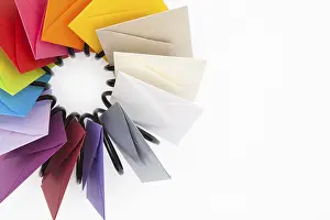 Studio Shot Communication Drucke: Propeller of colored envelopes on the white table