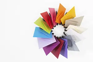 White Table Studio Shot Drucke: Propeller of colored envelopes on the white table