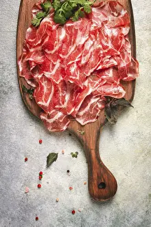 Salami Sausage Drucke: Prosciutto on a cutting board, top view