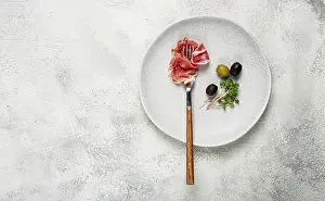 Gourmet Snack Meal Drucke: Prosciutto on a fork, top view