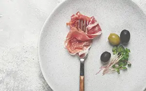 Italian Cuisine Image Drucke: Prosciutto on a fork, top view