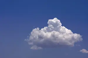 Blue Sky Drucke: Puffy clouds on a blue sky
