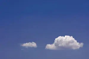 Blue Sky Drucke: Puffy clouds on a blue sky