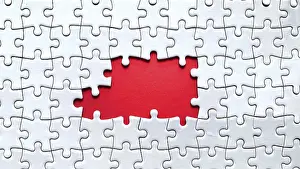 Copy Space Image Drucke: Puzzle with multiple missing pieces revealing a red section