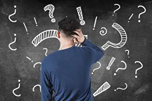 Frustrated Male Drucke: Puzzled man from back of a blackboard