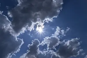 Cloudy Weather In Europe Drucke: Rain clouds with sun in backlight