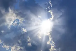 Sunbeams Through Clouds Drucke: Rain clouds with sun shining through