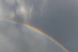 Rainbow In Rain Clouds Drucke: Rainbow appears in rain clouds in spring
