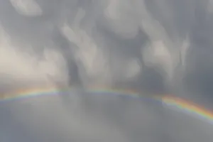Prismatic Colors In Spring Drucke: Rainbow appears in rain clouds in spring