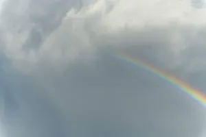 Rainbow In Rain Clouds Drucke: Rainbow appears in rain clouds in spring