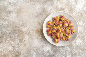 Brown Concrete Backgrounds Drucke: Rainbow colored dumplings with pepper
