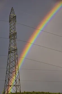 Rainbow In Europe Drucke: Rainbow behind a high-voltage pylon