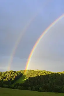 Central Europe Wooded Landscape Drucke: Rainbow in a hilly landscape with forest
