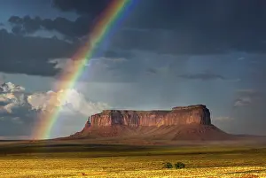 Eroded Landscape Pictures Drucke: Rainbow at Monument Valley, cloudy sky