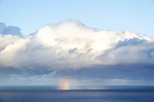 Prismatic Colors In The Sky Drucke: Rainbow over sea, dark rain cloud