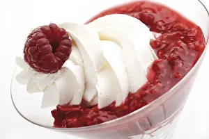 Studio Shot Sweets Drucke: Raspberry puree with whipped cream and a raspberry on top