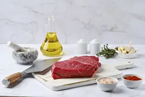 Beef Meat Nutrition Drucke: Raw top side beef steak with spice and herbs on kitchen table